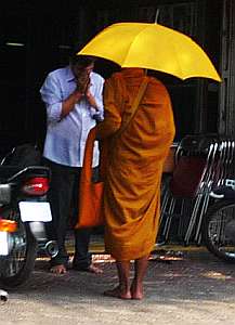 Man praying before a monk