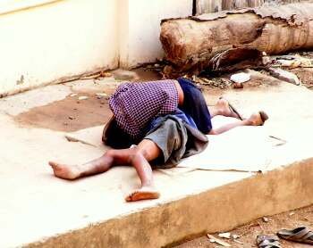 Two street kids playing on the road