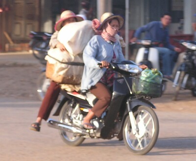 Two women and cargo on a motorcycle