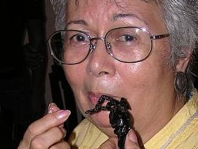 Roberta eating a tarantula