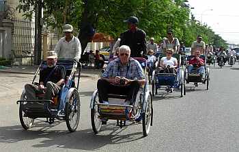 Tourists riding cyclos