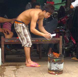 Young man burning an offering