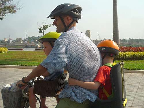 Father and two sons on a bicycle
