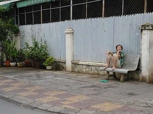 Woman sitting out on the street