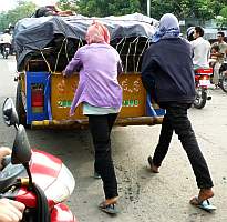 Pushing a wagonload of charcoal