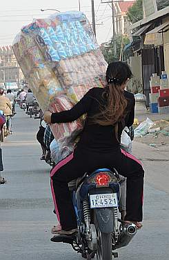 Girl with a load on a motorcycle